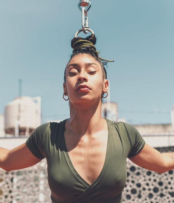 Woman performing a controlled balance exercise in a calm setting.